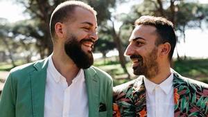Gay couple smiling standing s300
